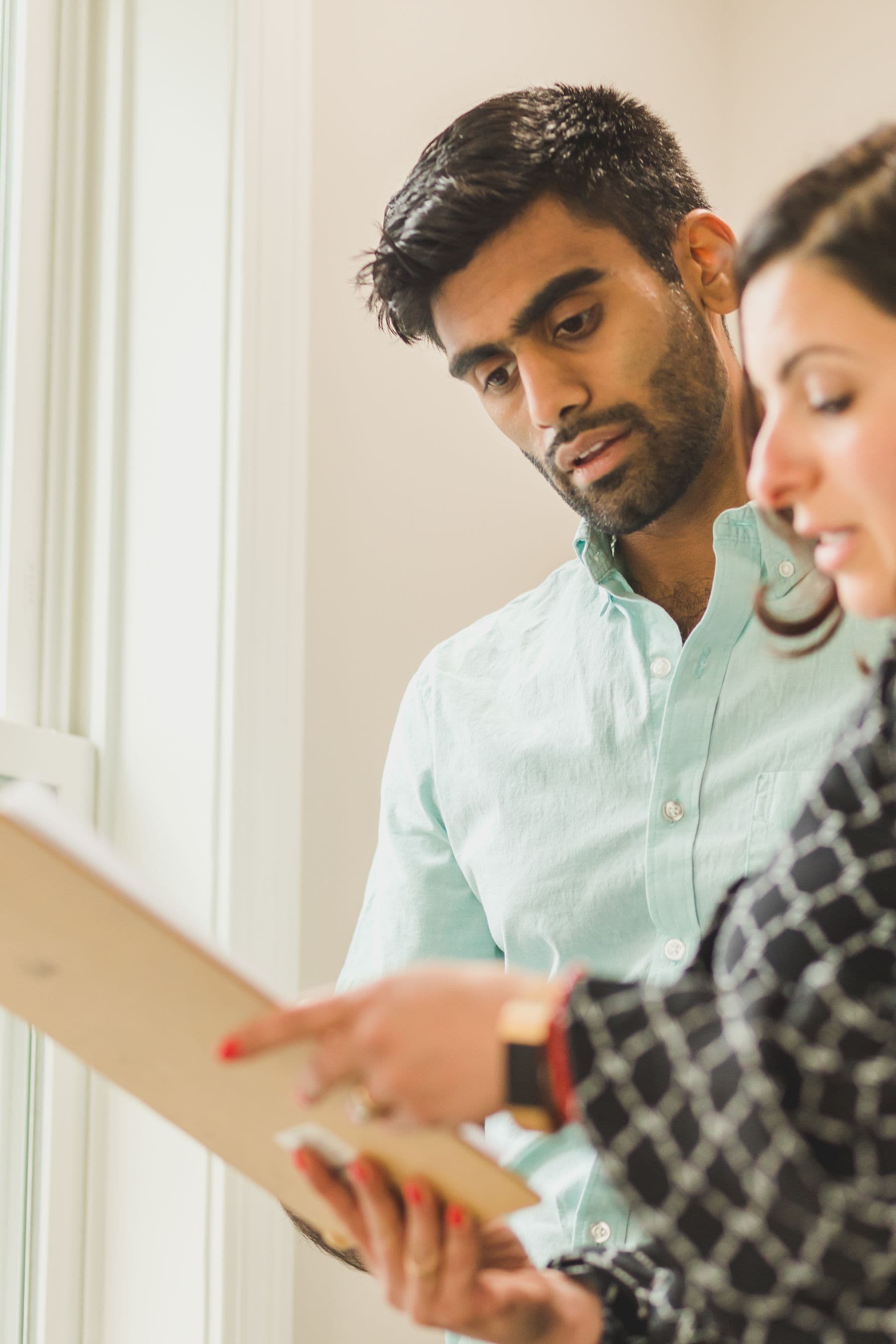 Two people look through a document together.